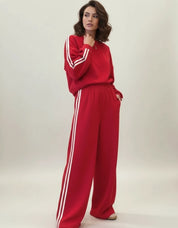Red Adidas tracksuit set with white stripes, crewneck top, and sweatpants