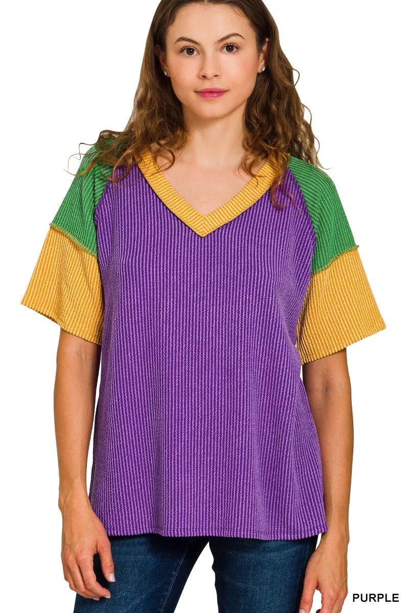 Purple ribbed v-neck top with green and yellow raglan sleeves