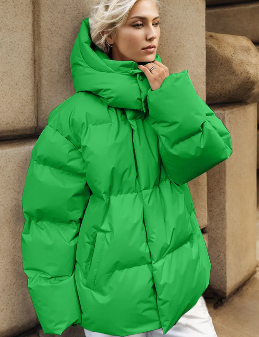 Green hooded puffer jacket with pockets, zip-up, and oversized sleeves