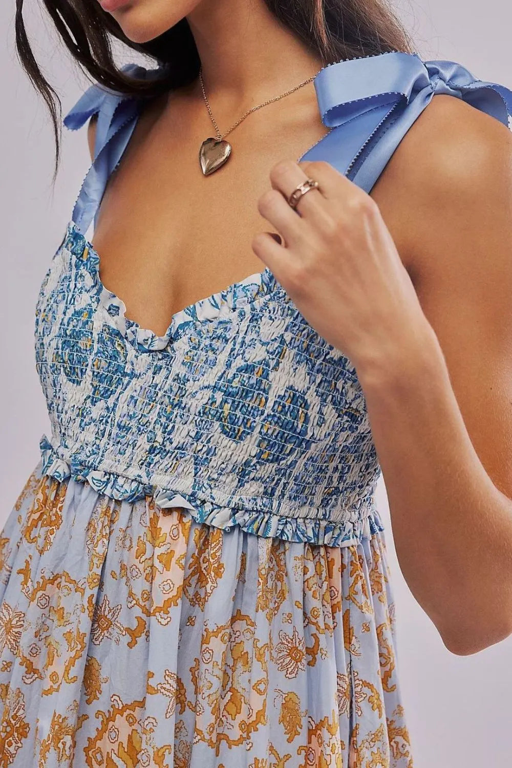 Floral tiered maxi dress in blue white pattern with gold floral accents smocked bodice ribbon shoulder ties