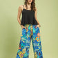 Umgee floral print wide-leg pants in vibrant blue, yellow, orange with frayed hem