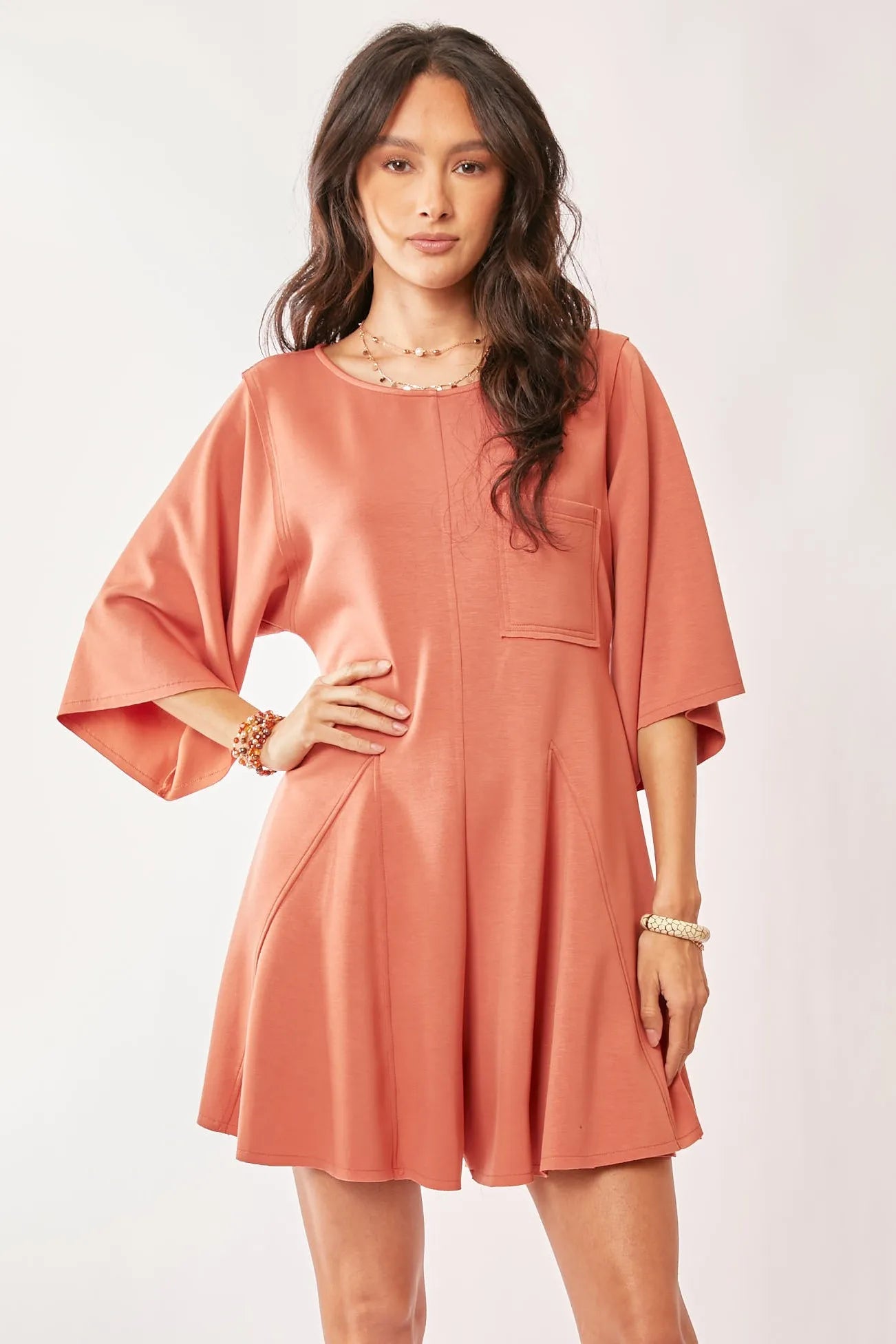 Davi & Dani soft peach satin romper with draped bell sleeves and flared skirt