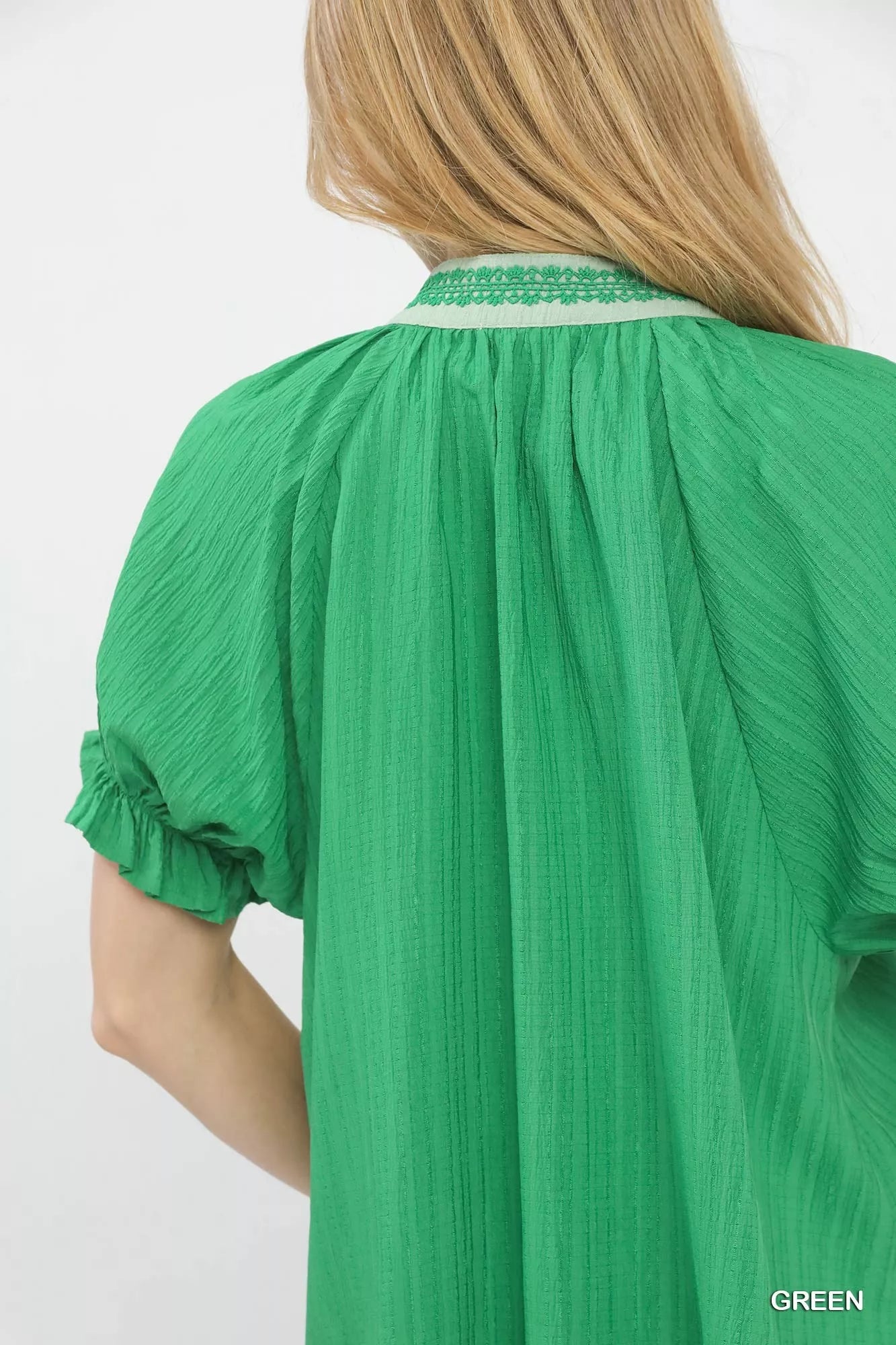 Vibrant green Umgee textured V-neck top with lace trim, gathered neckline and ruffled sleeves