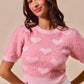 Pink fuzzy cropped SO ME sweater with white heart patterns