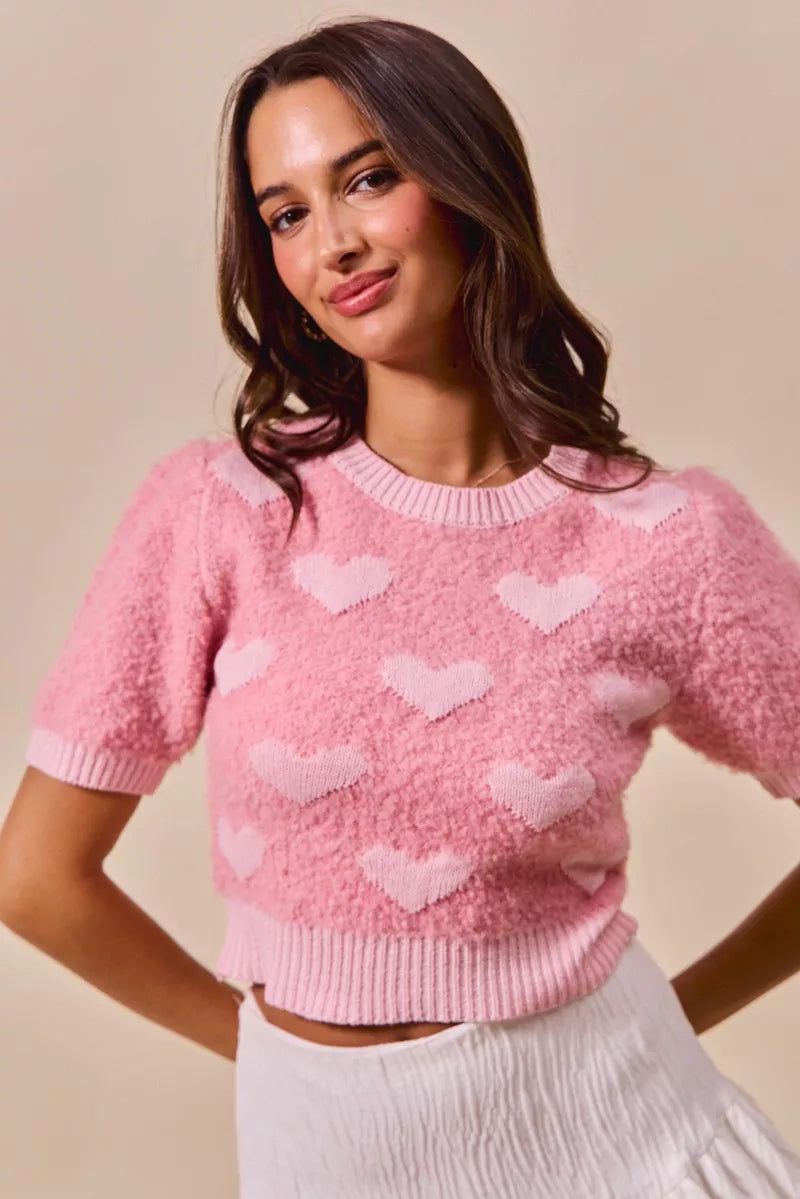 Pink fuzzy cropped SO ME sweater with white heart patterns