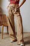 Beige wide-leg sweatpants with drawstring waist, pockets, and side seams