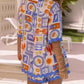 Vibrant bohemian print kaftan dress in white, blue, orange with scalloped edges