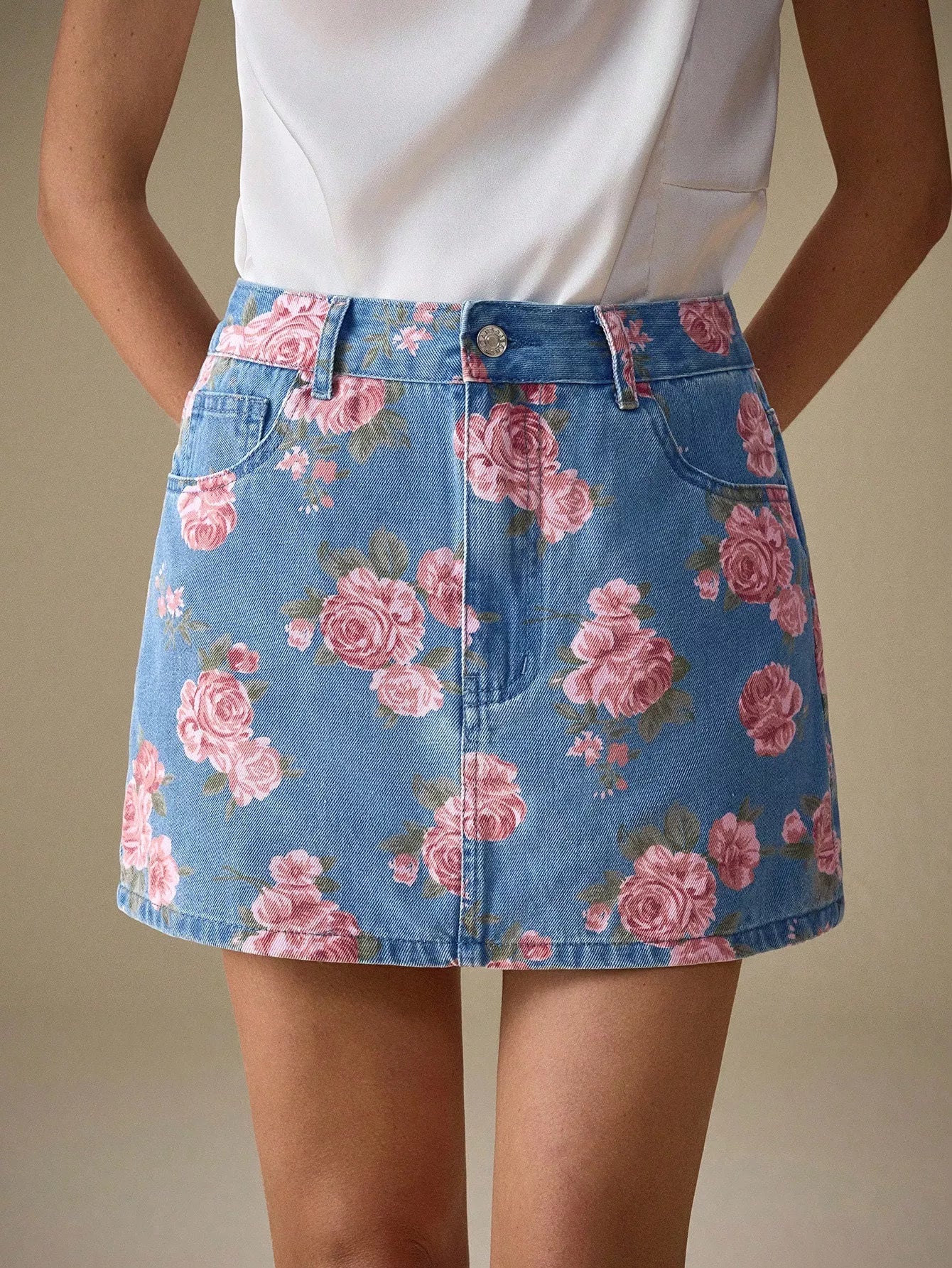 Vibrant pink rose floral print on medium-wash blue denim mini skirt