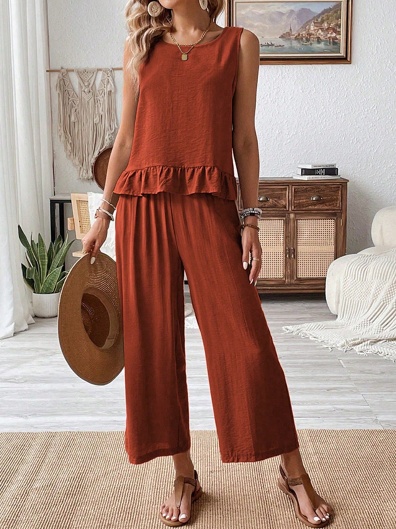 Rust-colored sleeveless Daverri ruffle hem tank top back view