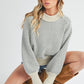 Cozy off-white Aemi + Co Echo loose fit knit sweater with geometric pattern