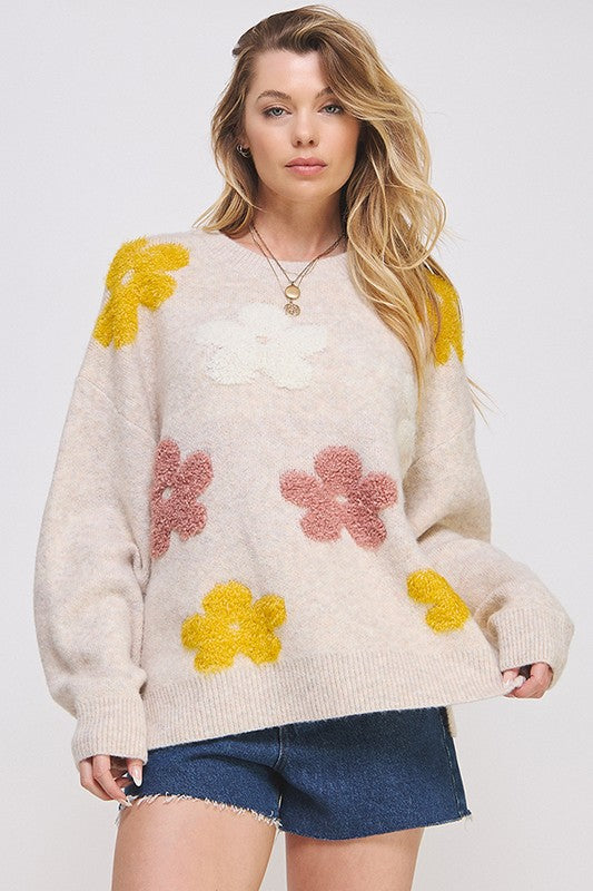 Cream-colored oversized knit sweater with fluffy yellow and pink floral appliques by Jade by Jane