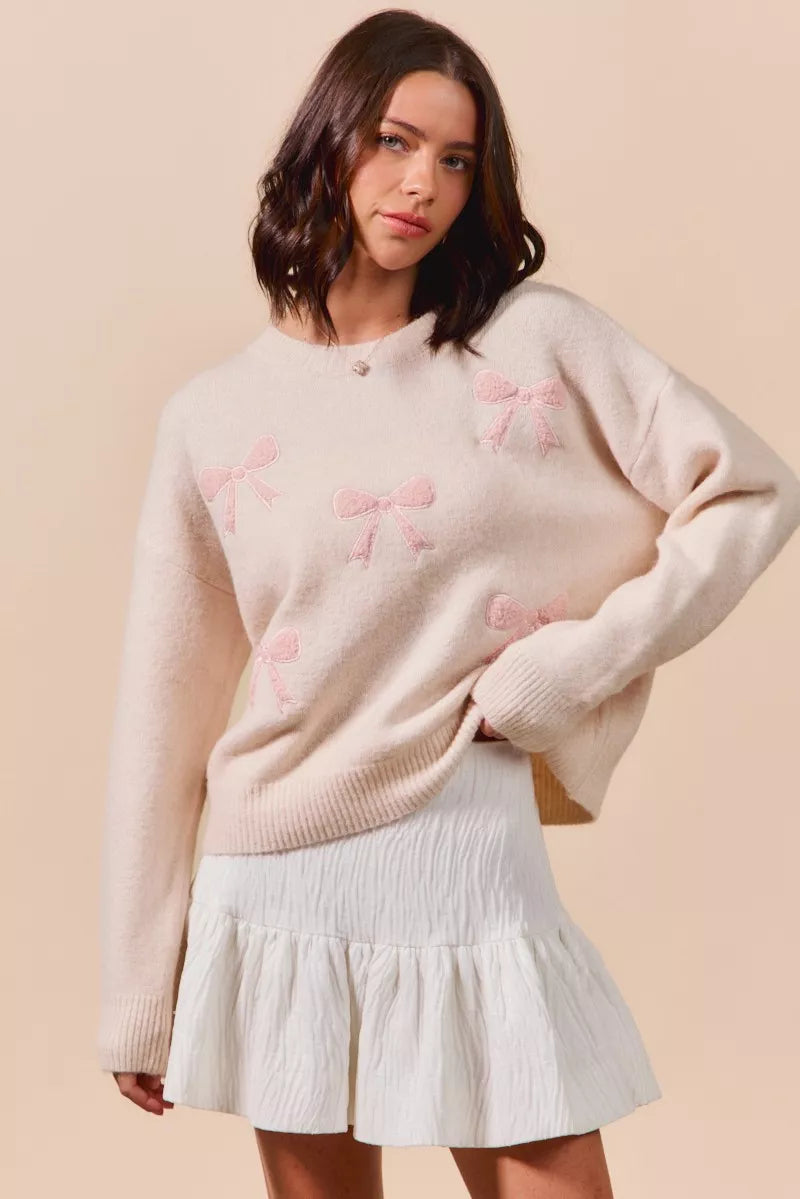Cream-colored SO ME knit sweater with pink embroidered bows