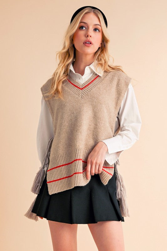 Beige and red striped knit vest poncho with tassels by Aemi + Co