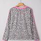 Women’s black and white leopard print V-neck long sleeve top with pink trim