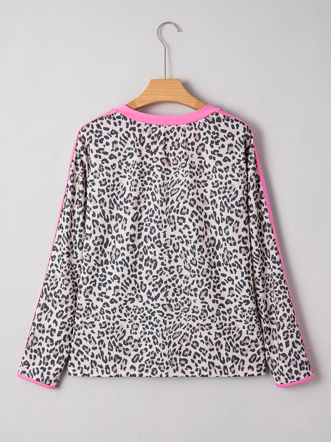 Women’s black and white leopard print V-neck long sleeve top with pink trim