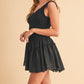 Black sleeveless mini Love Drop Waist Dress with ruffled hem and elastic waistband