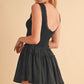 Black sleeveless Love Drop Waist mini dress with lace-trimmed back and ruffled skirt