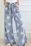 Blue denim wide-leg jeans with white star print and drawstring waist