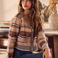 Woman in SO ME textured variegated beige brown striped knit cardigan with lace