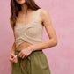 Beige crocheted crop top with thin straps on twill shorts