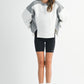 Woman in Colorblock Terry Pullover Sweatshirt with biker shorts
