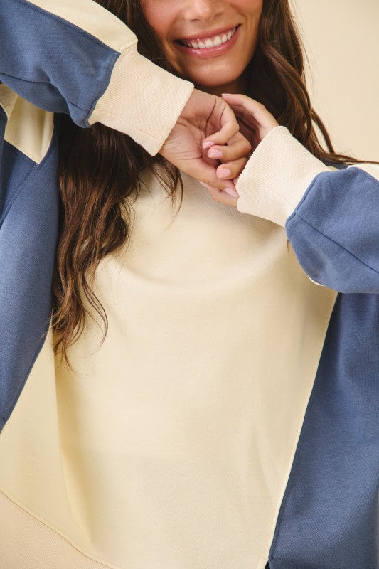 Cream-colored and navy blue color-blocked terry pullover sweatshirt with ribbed cuffs