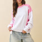 Pink and white color-blocked long-sleeve terry pullover sweatshirt with ribbed cuffs