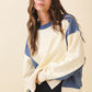 Colorblock terry pullover sweatshirt in cream and navy blue with ribbed cuffs