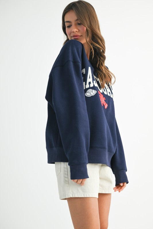 Back of Aemi + Co East Coast graphic fleece sweatshirt size S, navy blue oversized with white and red lettering