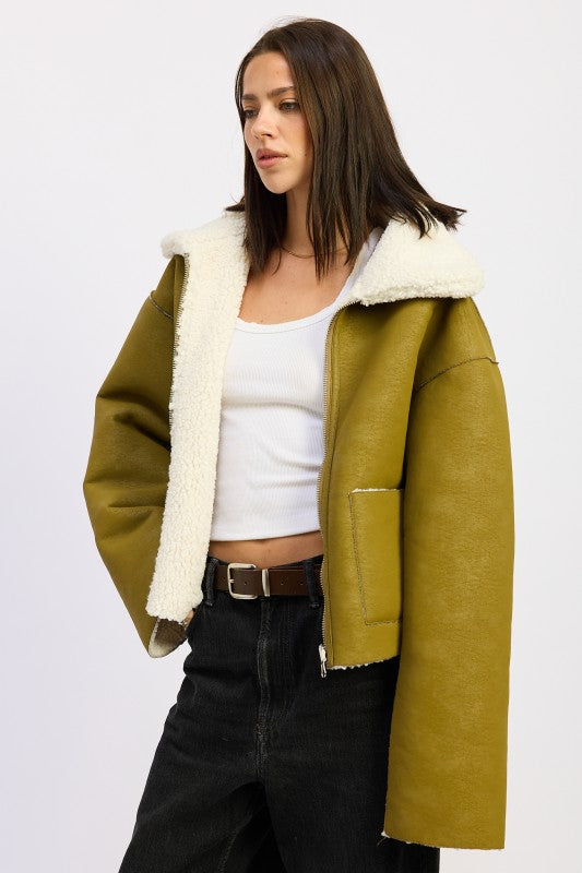 Reversible suede shearling jacket in olive green with plush white lining