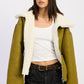Reversible suede shearling jacket in olive green with plush white interior