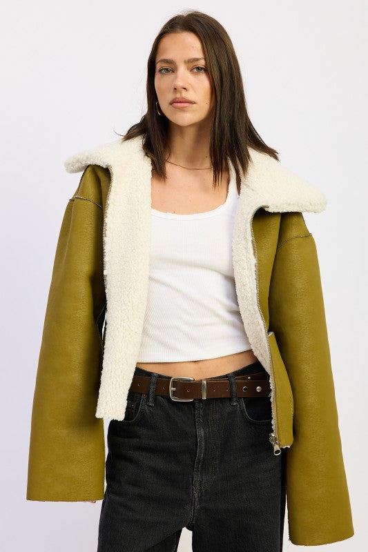 Reversible suede shearling jacket in olive green with plush white interior