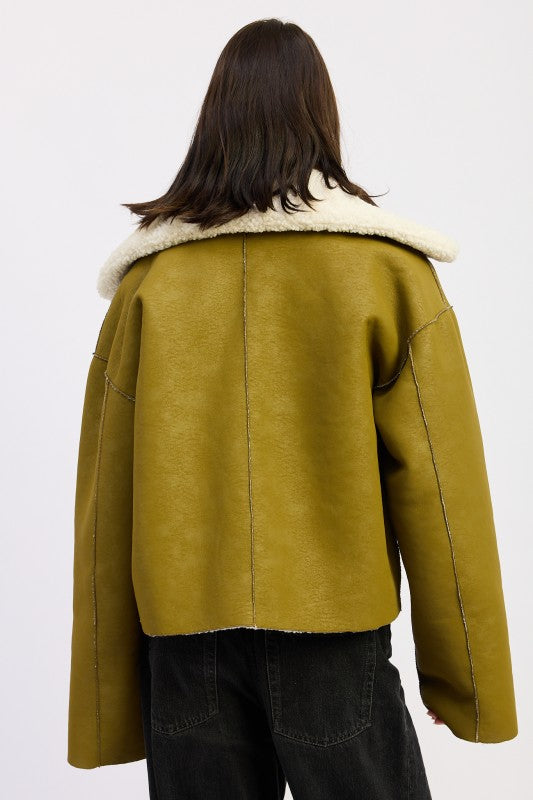 Reversible suede shearling jacket in olive green with plush white fur collar