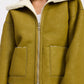 Olive green shearling-lined reversible suede bomber jacket with zipper and flap pockets