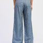 Belted wide-leg denim trousers in medium-wash blue with relaxed fit