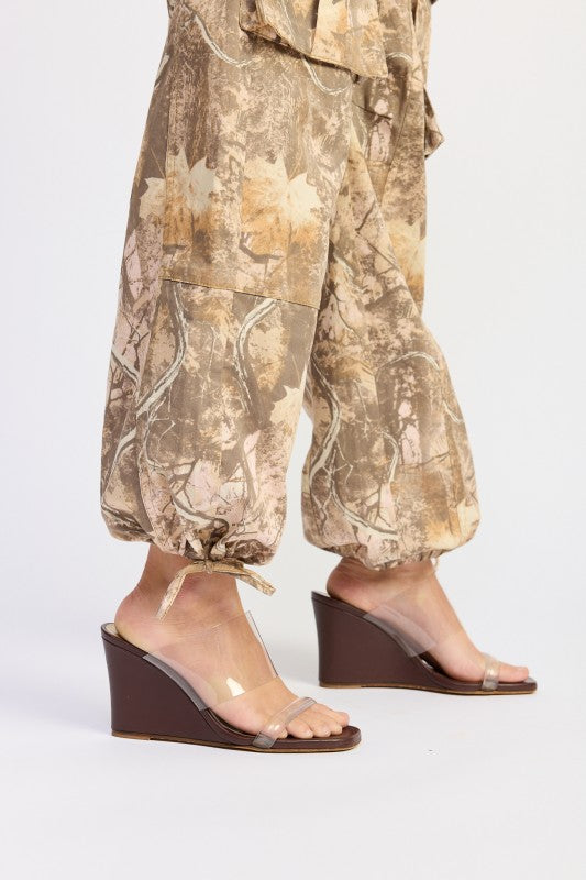Transparent wedge sandals with brown heel and toe strap