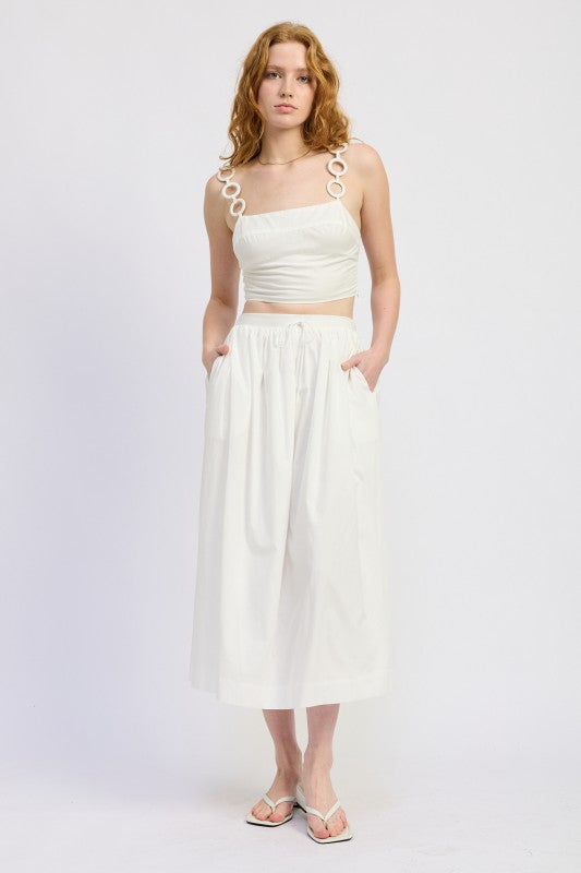 White cropped top with circular chain strap detail on Emory Park skirt