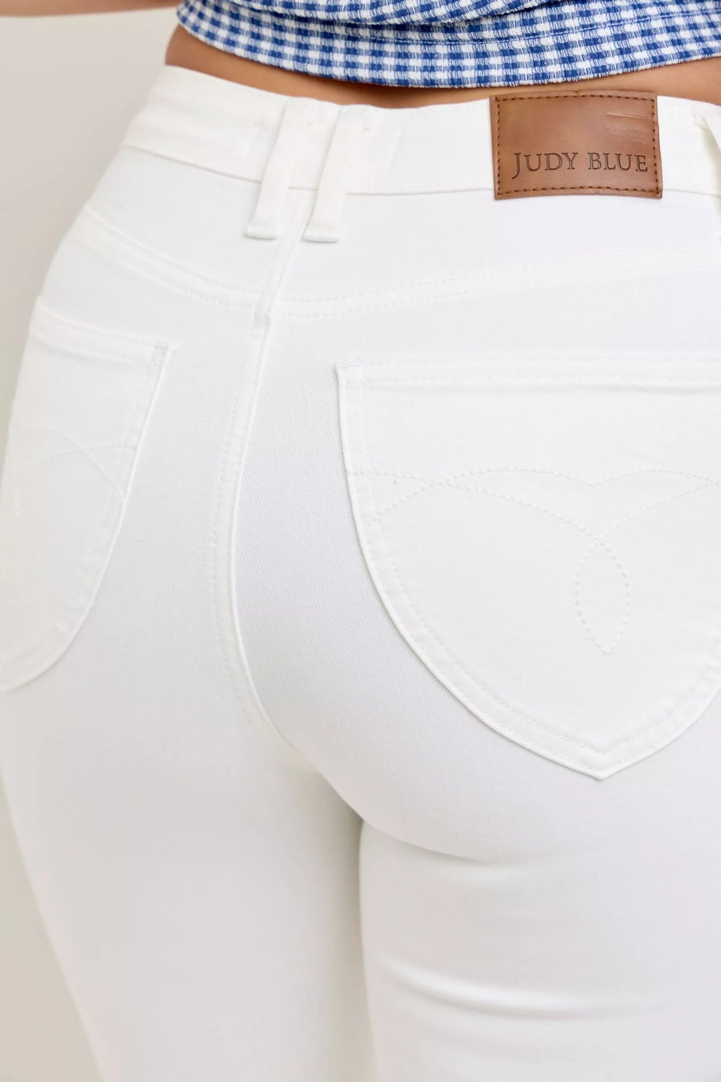 Judy Blue high-waisted tummy control flare jeans in white denim with brown leather patch
