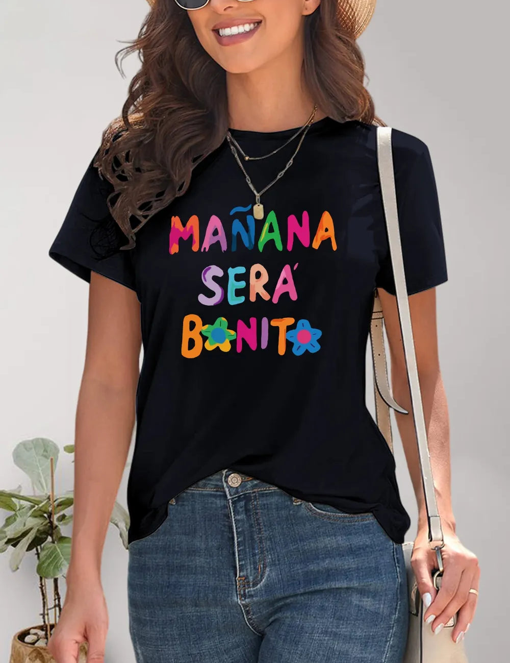 Black short-sleeve t-shirt with Manana Sera Bonita graphic and floral accents