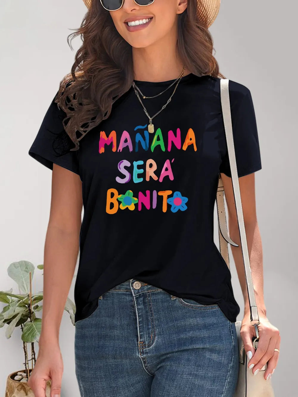 Black short-sleeve t-shirt with Manana Sera Bonita graphic and floral accents
