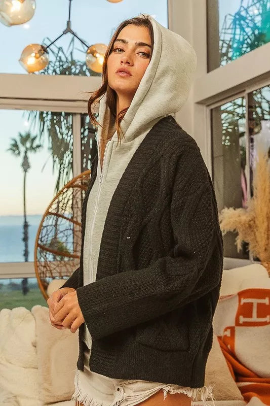 Black cable-knit cardigan over light gray hoodie in BiBi Knit Hoodie Rhombus Sweater Jacket