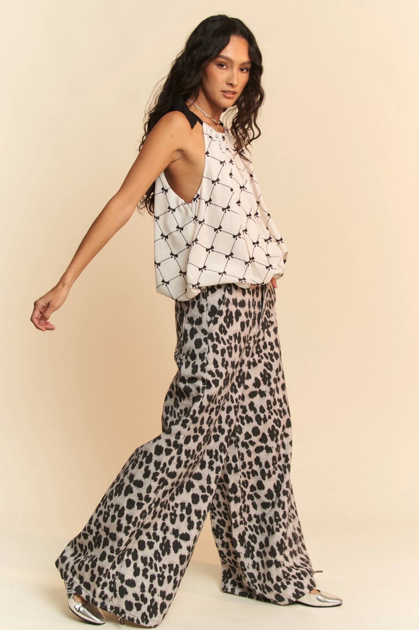 Woman in Davi & Dani ribbon checker halter blouse with leopard pants