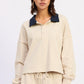 Beige cropped sweatshirt with navy contrast collar and buttons