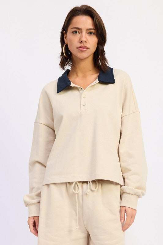 Beige cropped sweatshirt with navy contrast collar and buttons