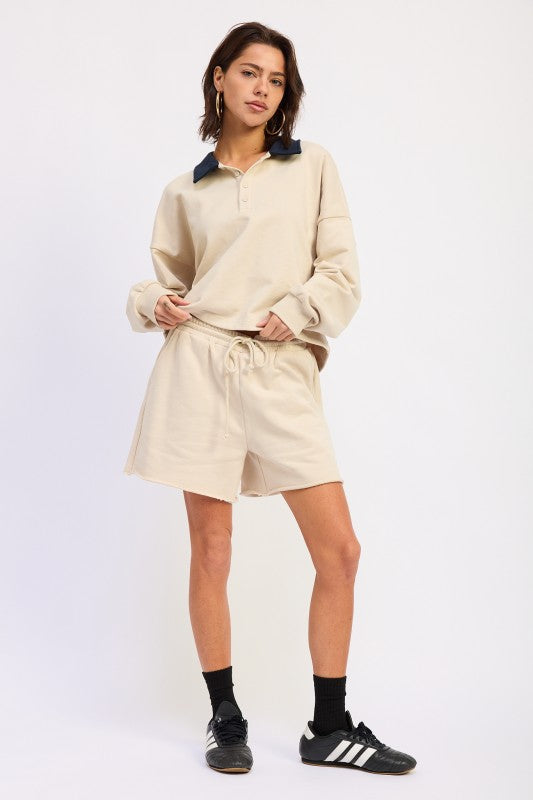 Beige oversized rugby pullover top with navy contrast collar