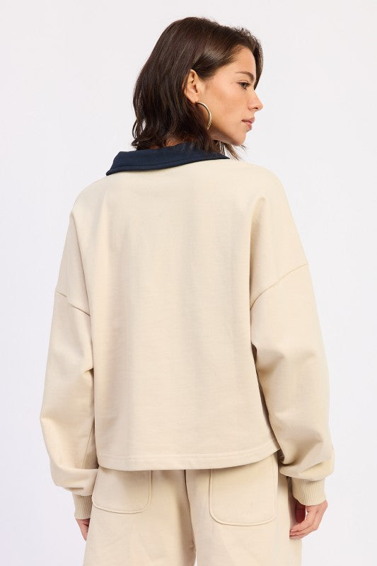 Beige oversized sweatshirt with navy blue contrast collar pullover top