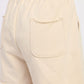 Cream-colored French terry shorts with pockets, relaxed fit, elastic waistband