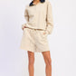 Beige oversized polo shirt with navy collar and drawstring shorts