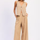 Beige v-neck sleeveless vest with button closure on Emory Park linen pants