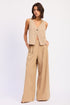 Beige v-neck sleeveless vest with button closure on Emory Park linen pants